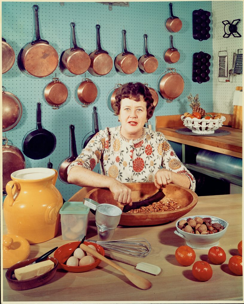 Julia Child cooking in a kitchen