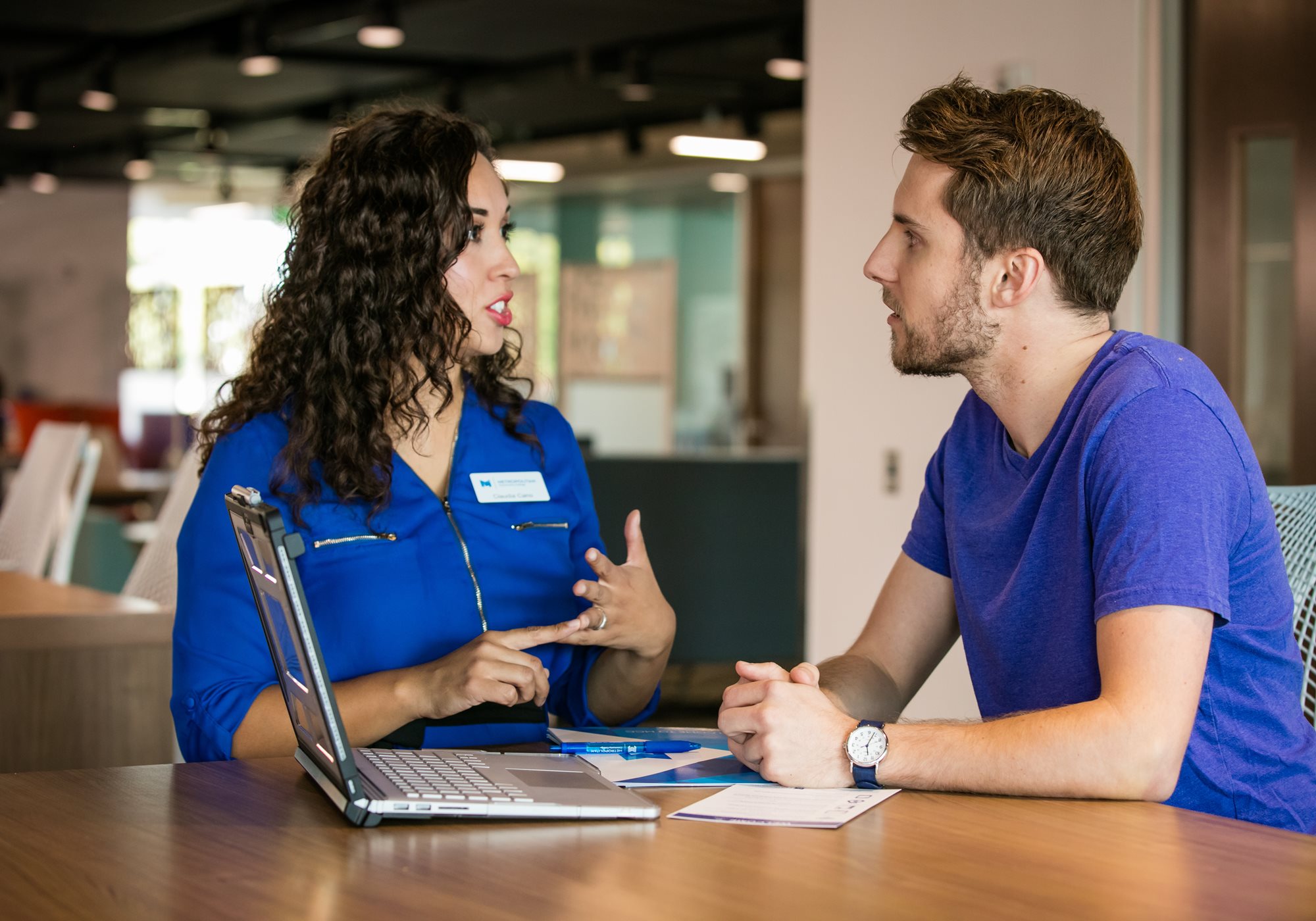 Female employee helping Male Customer