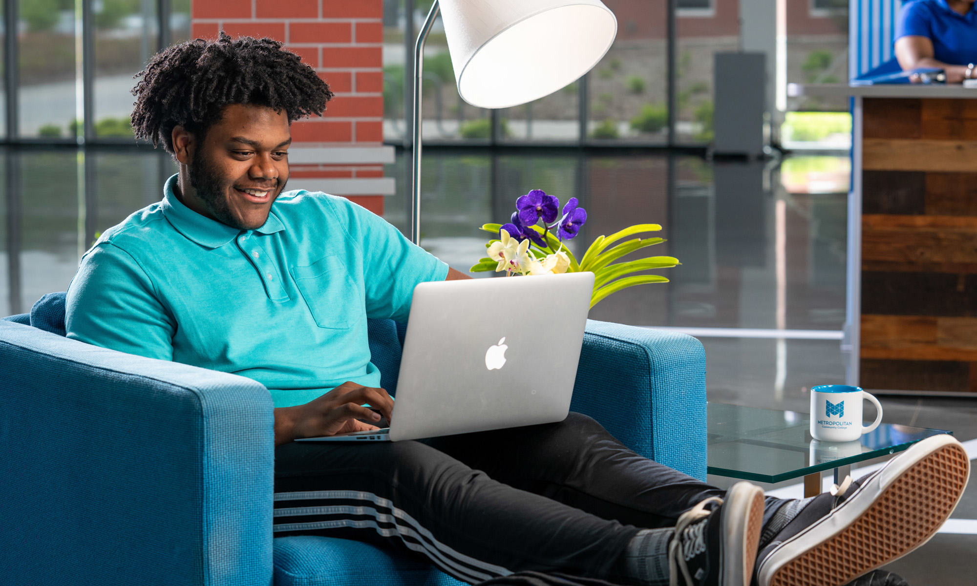 Happy student working on laptop