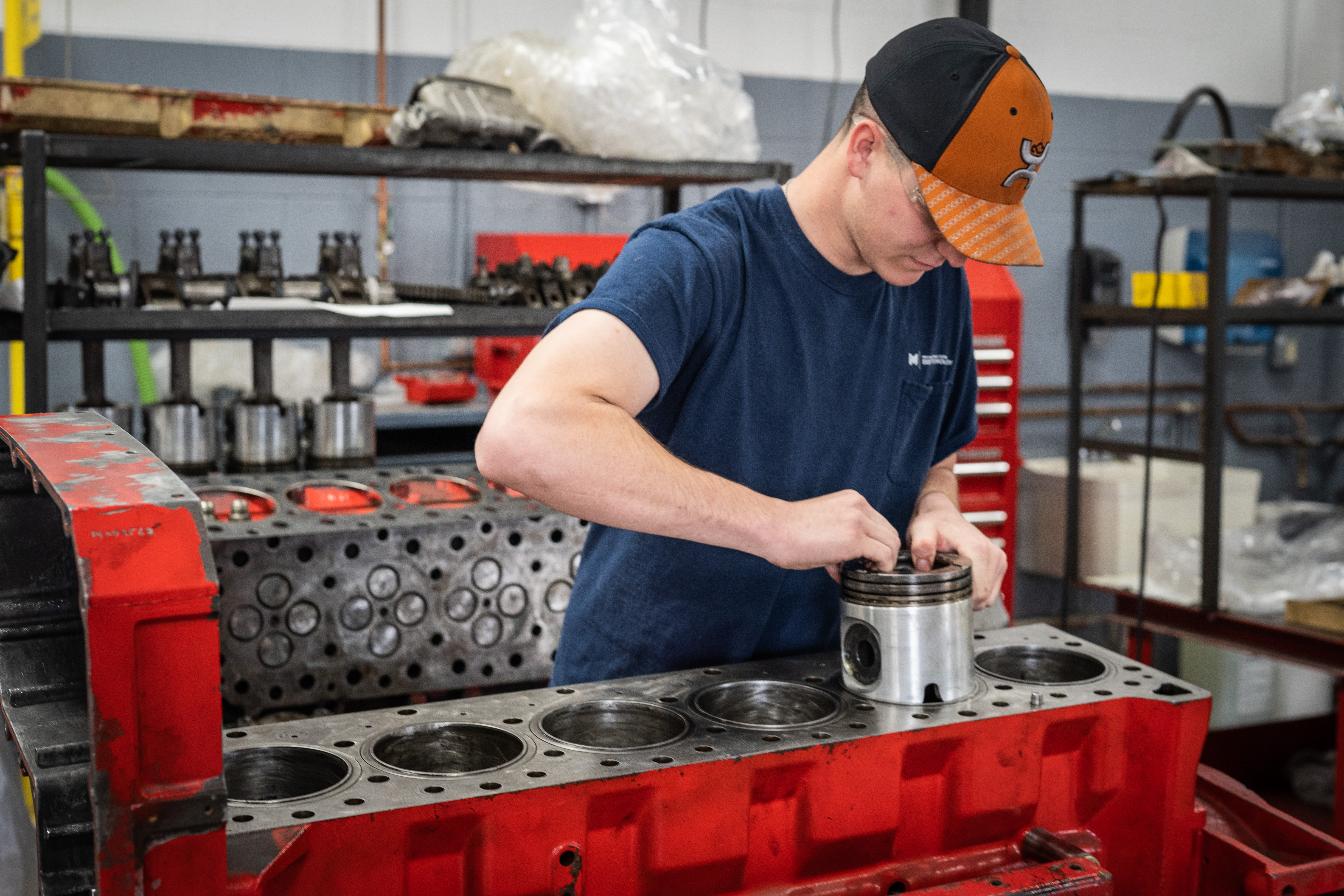 A man working on a diesel project in a classroom setting. 
